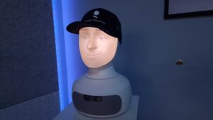 Robot społeczny Furhat z wyświetlaną twarzą, w czapce z logo producenta